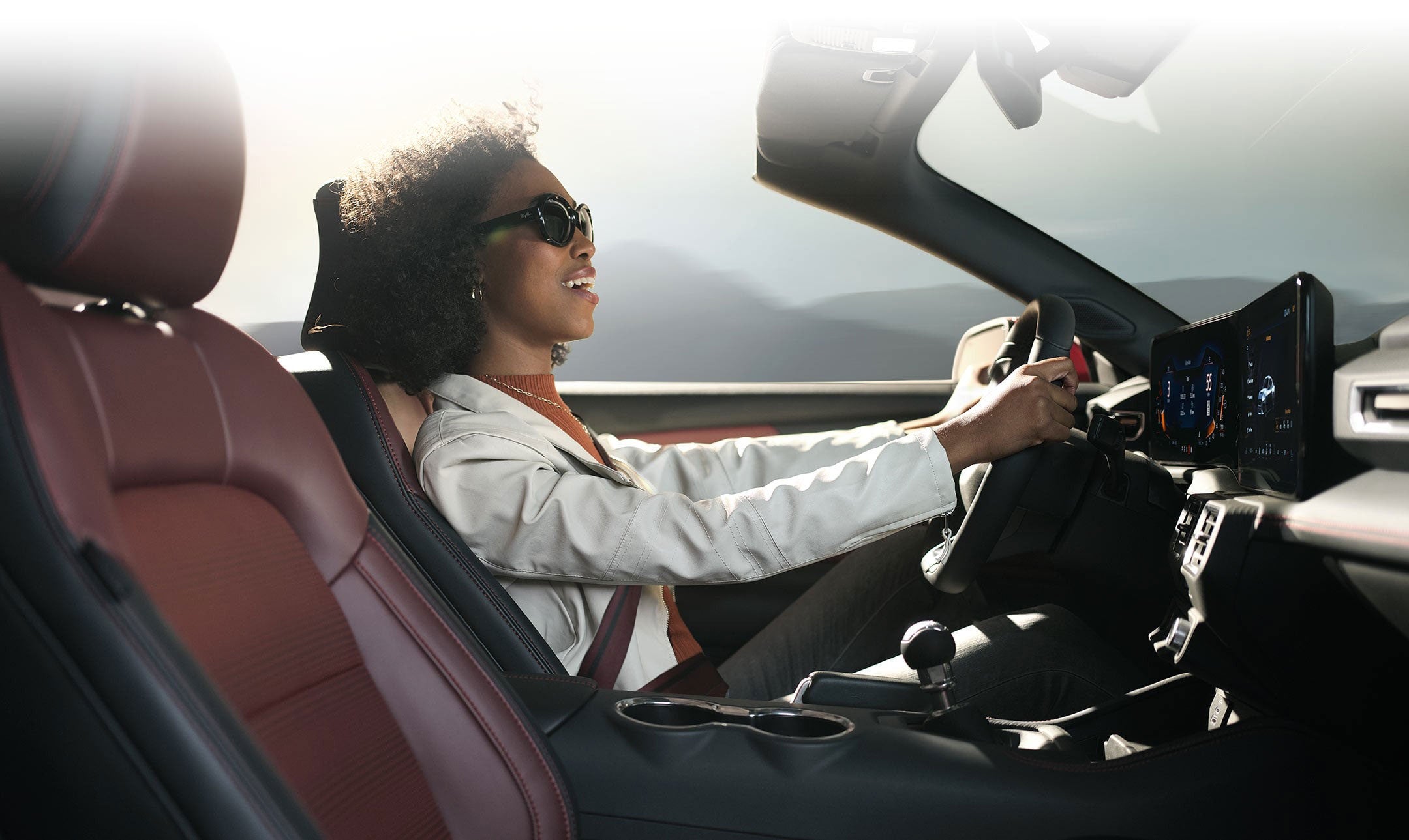 Person sitting in the driver’s seat of a 2024 Ford Mustang® convertible | Dotts Motor Co Inc in Clearfield PA